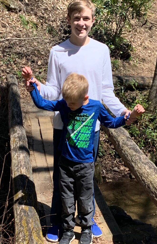 boy hiking with his nonverbal autistic brother