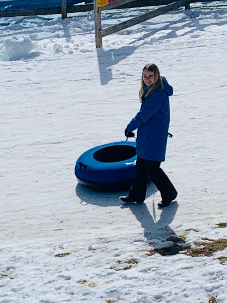 girl snowtubing