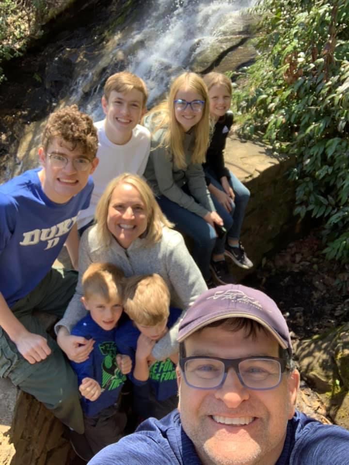 family with typical children and autistic children hiking together