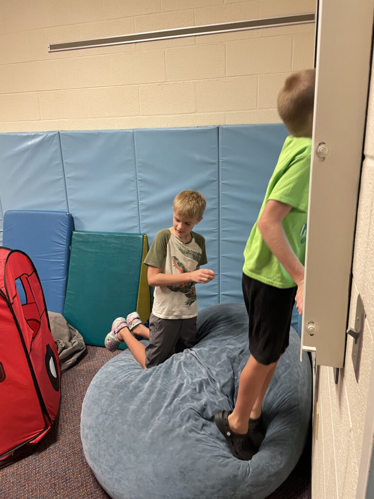 boys playing on beanbag chair