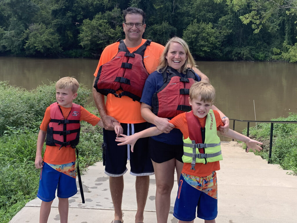 parents kayaking with twins